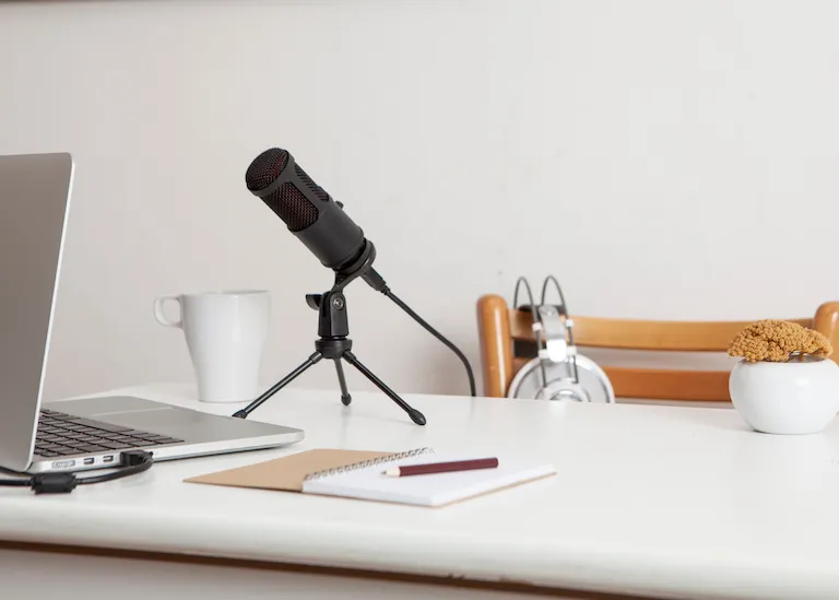 Microphone and notebook for podcast interview posted by Podpacer